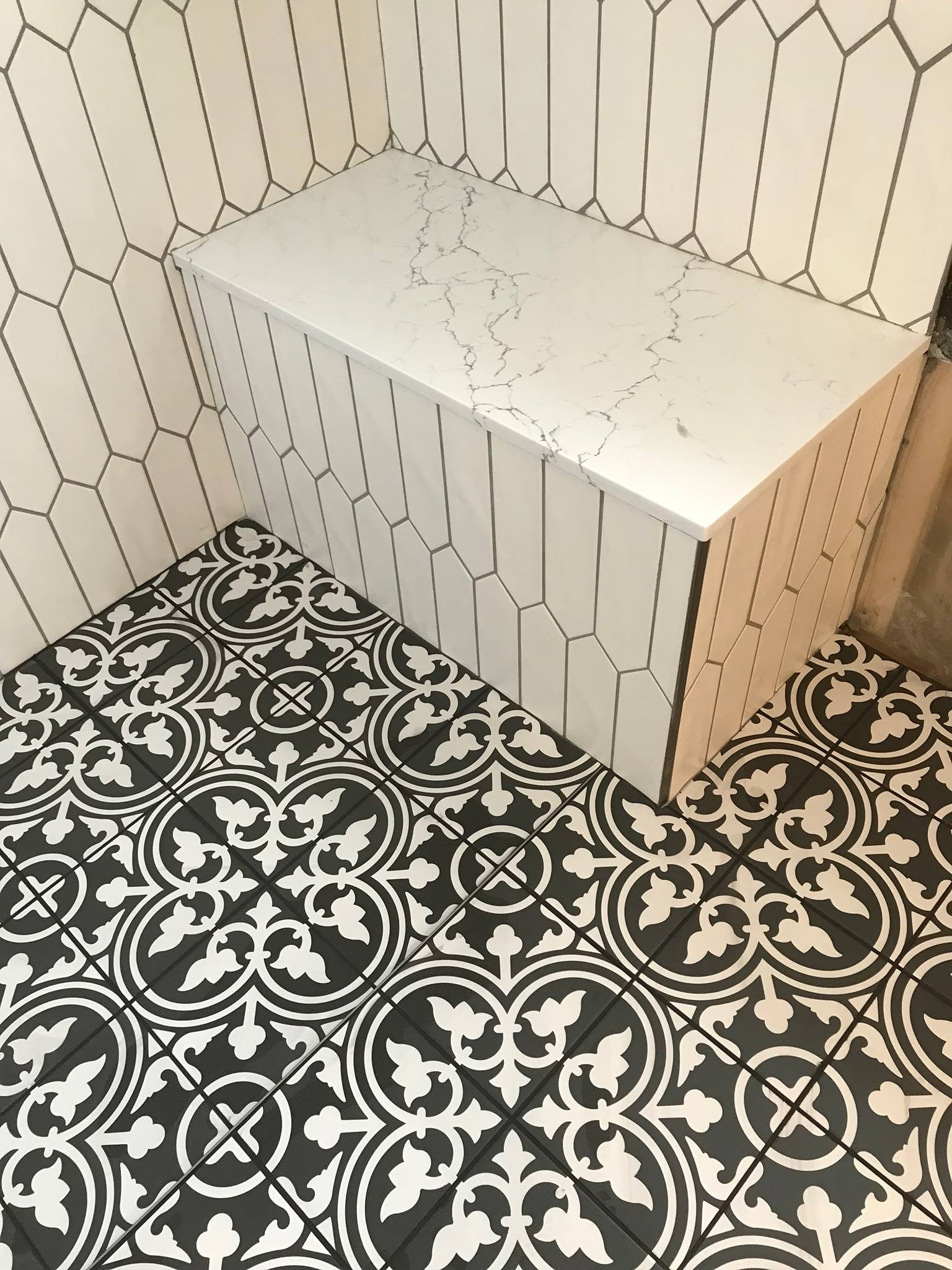 Custom shower with pattern floor and hex wall tile